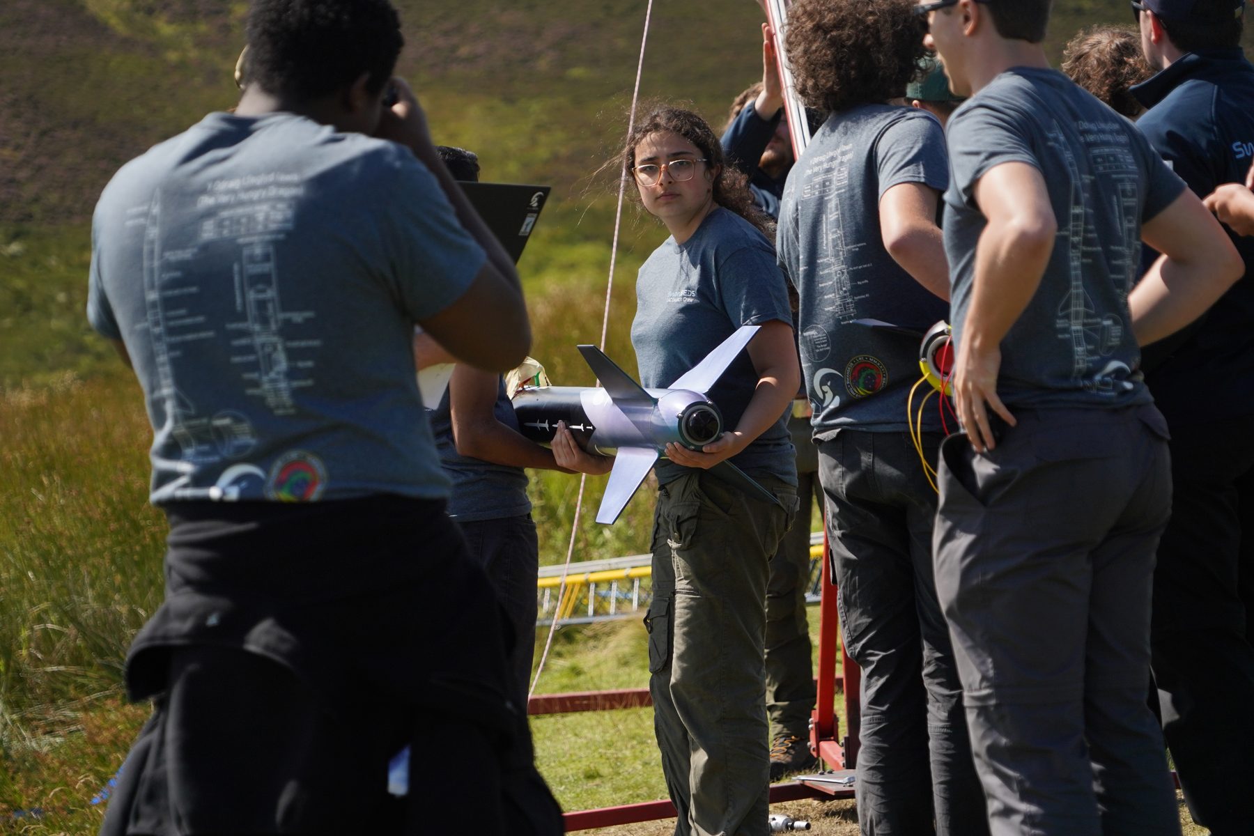 A university team preparing a rocket outdoors